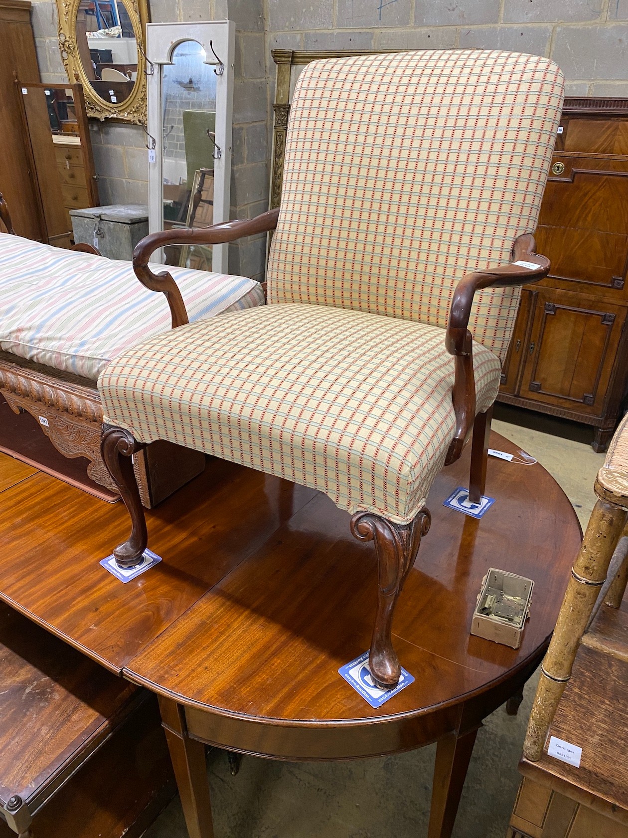 A George II style mahogany upholstered open armchair